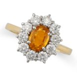 A YELLOW SAPPHIRE AND DIAMOND CLUSTER RING in 18ct yellow gold, set with an oval cut yellow sapphire