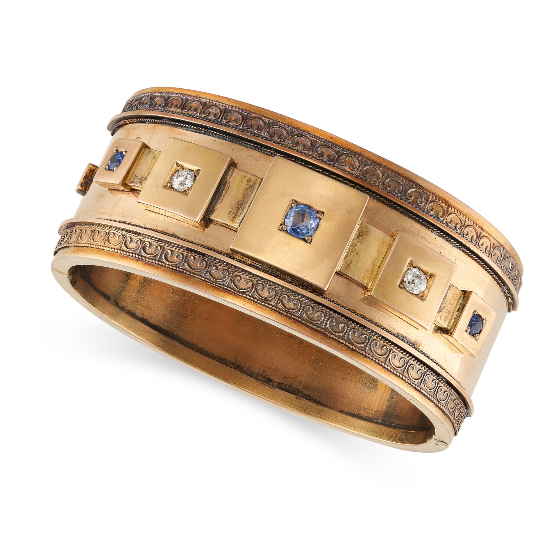 AN ANTIQUE SAPPHIRE AND DIAMOND BANGLE in yellow gold, set with a row of alternating round cut sa...