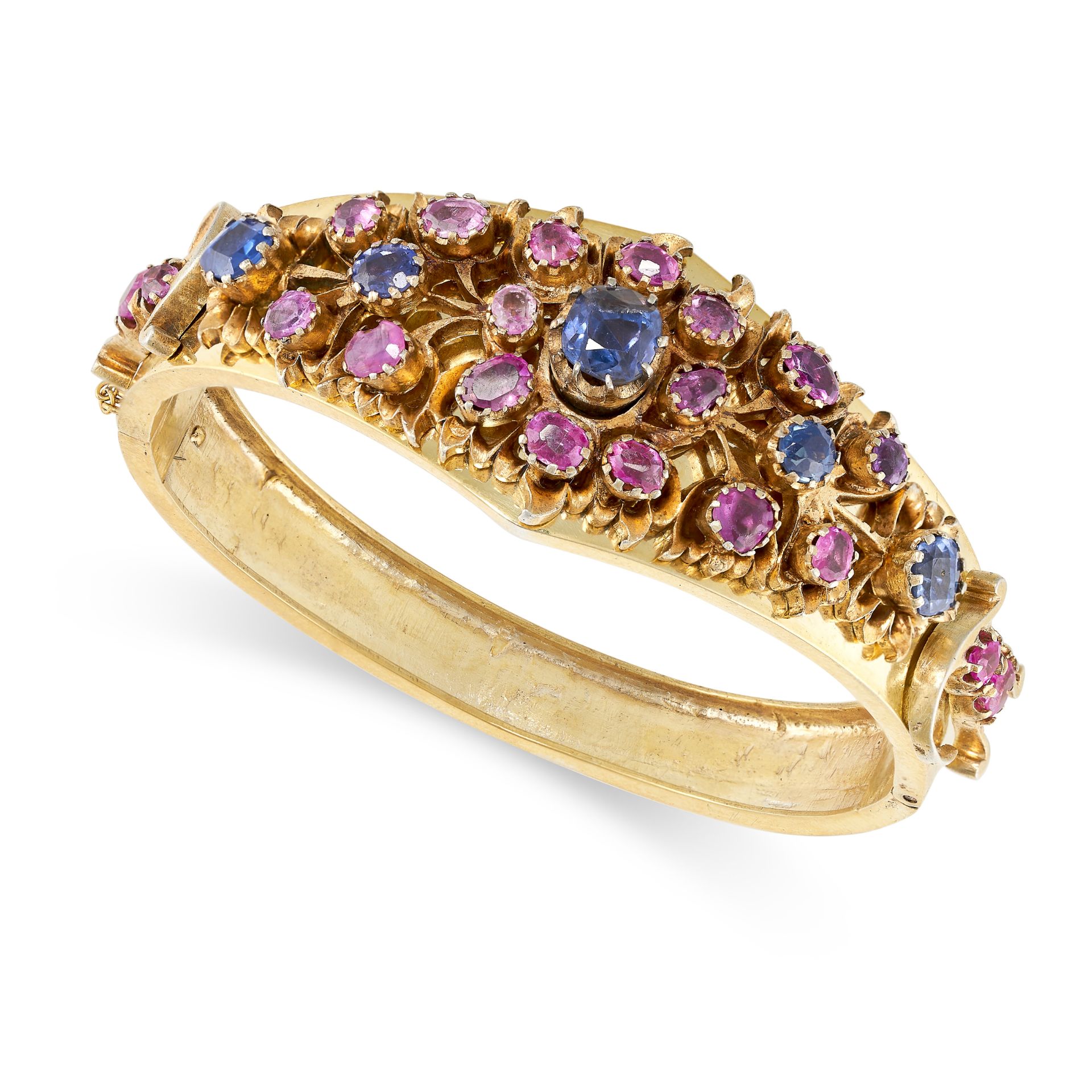 AN ANTIQUE SAPPHIRE BANGLE in yellow gold, set with a row of cushion and round cut sapphires acce...