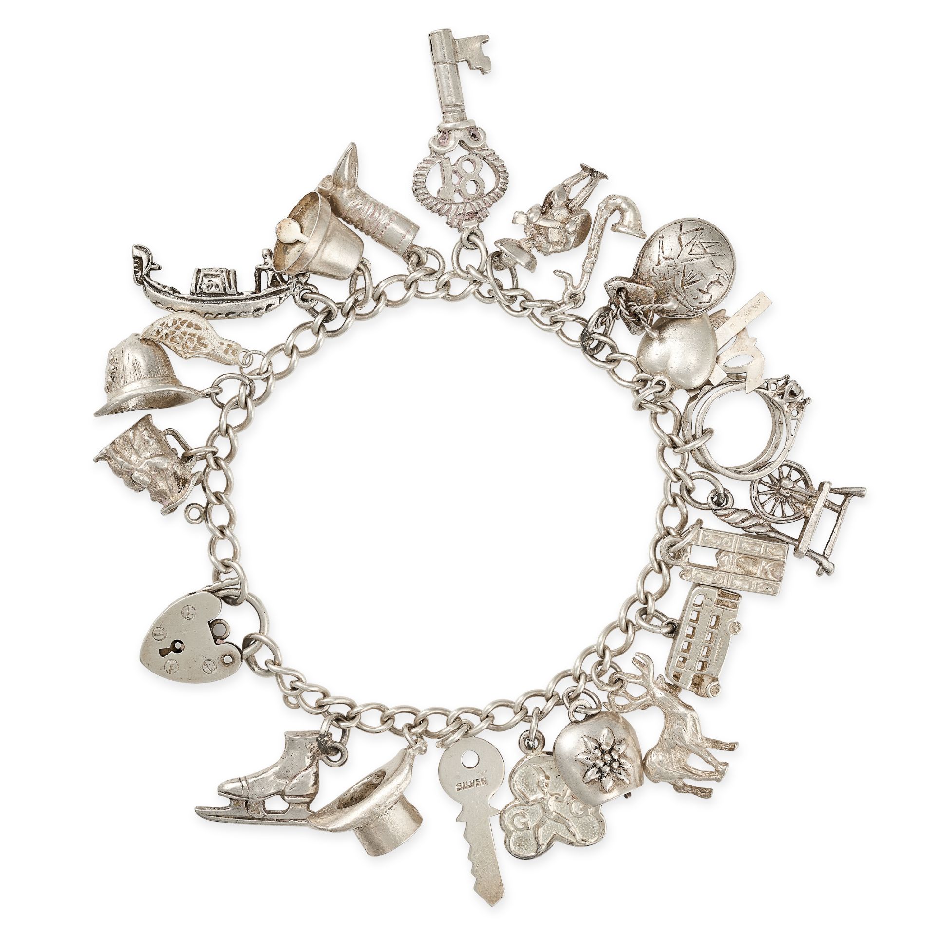 A CHARM BRACELET in silver, comprising a curb chain with a heart padlock clasp, suspending twenty...