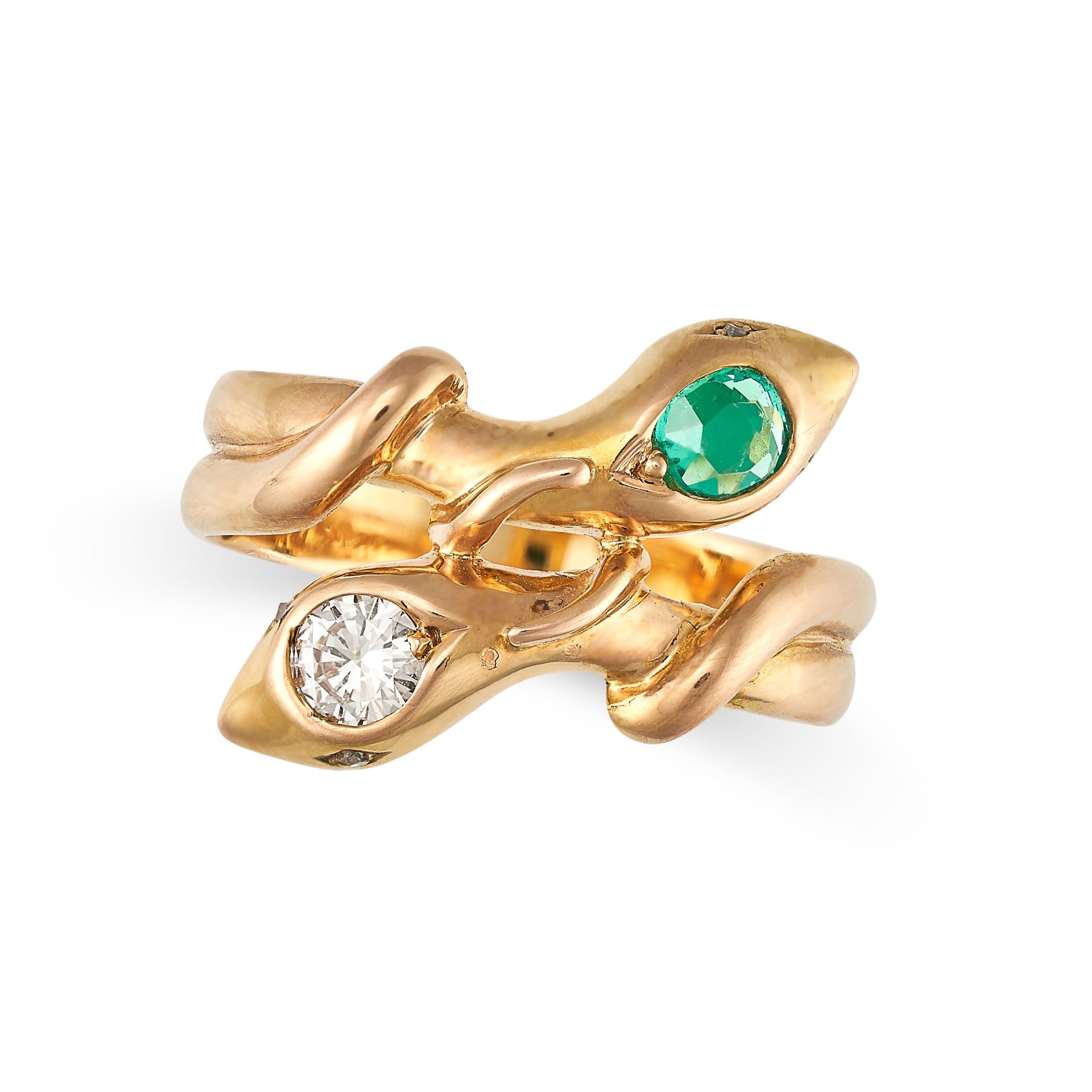 AN EMERALD AND DIAMOND SNAKE RING in yellow gold, designed as two snakes coiled around each other...