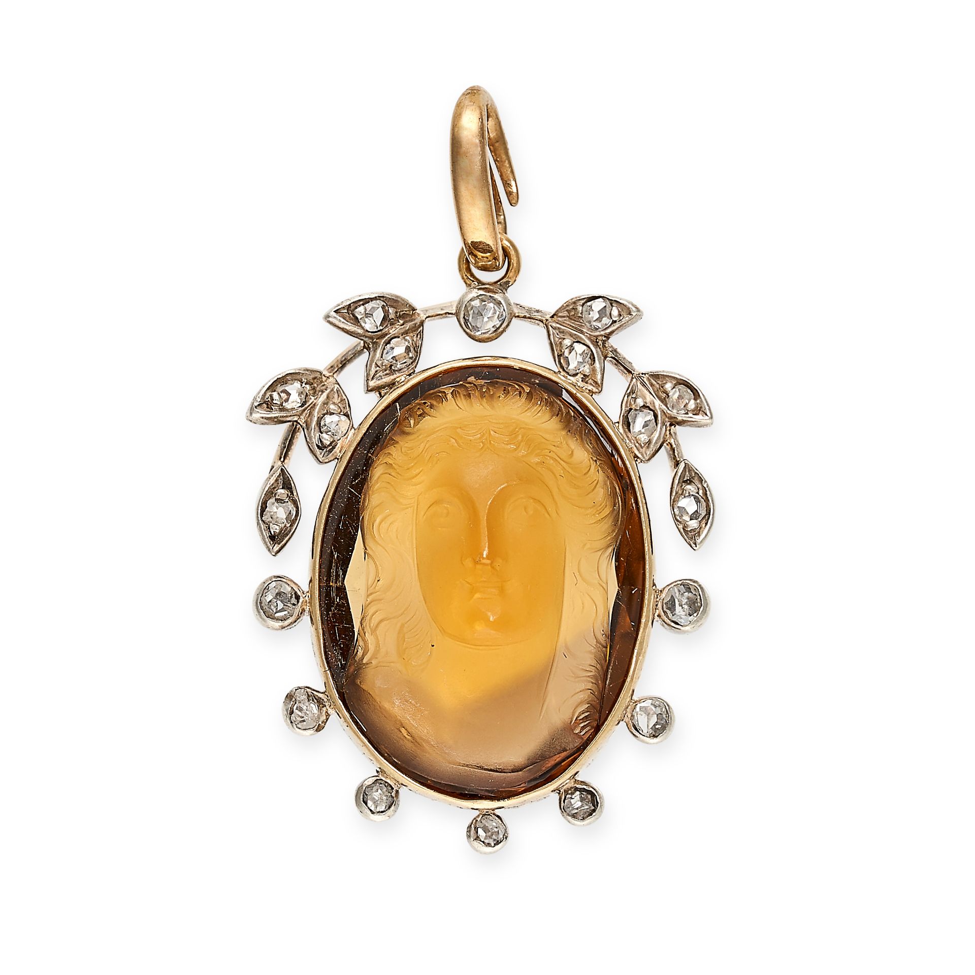 A CITRINE AND DIAMOND PENDANT in yellow gold, set with an oval citrine carved to depict the head ...