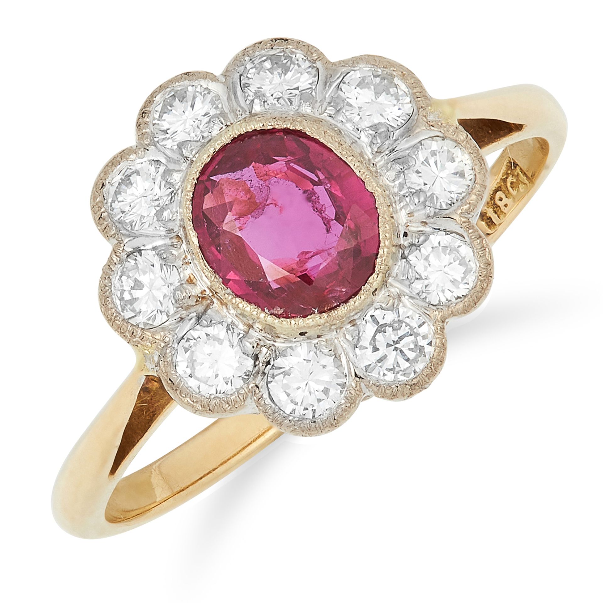 A RUBY AND DIAMOND CLUSTER RING set with an oval cut ruby of approximately 0.68 carats, in a bord...