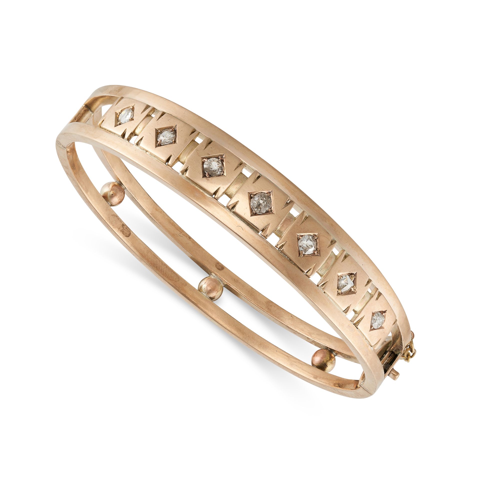 AN ANTIQUE DIAMOND BANGLE in yellow gold, the openwork bangle set with a row of seven old cut dia...