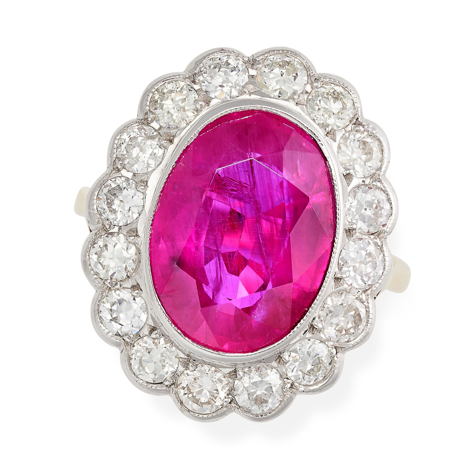 A RUBY AND DIAMOND CLUSTER RING in 18ct yellow gold, set with an oval cut ruby of approximately 7.05