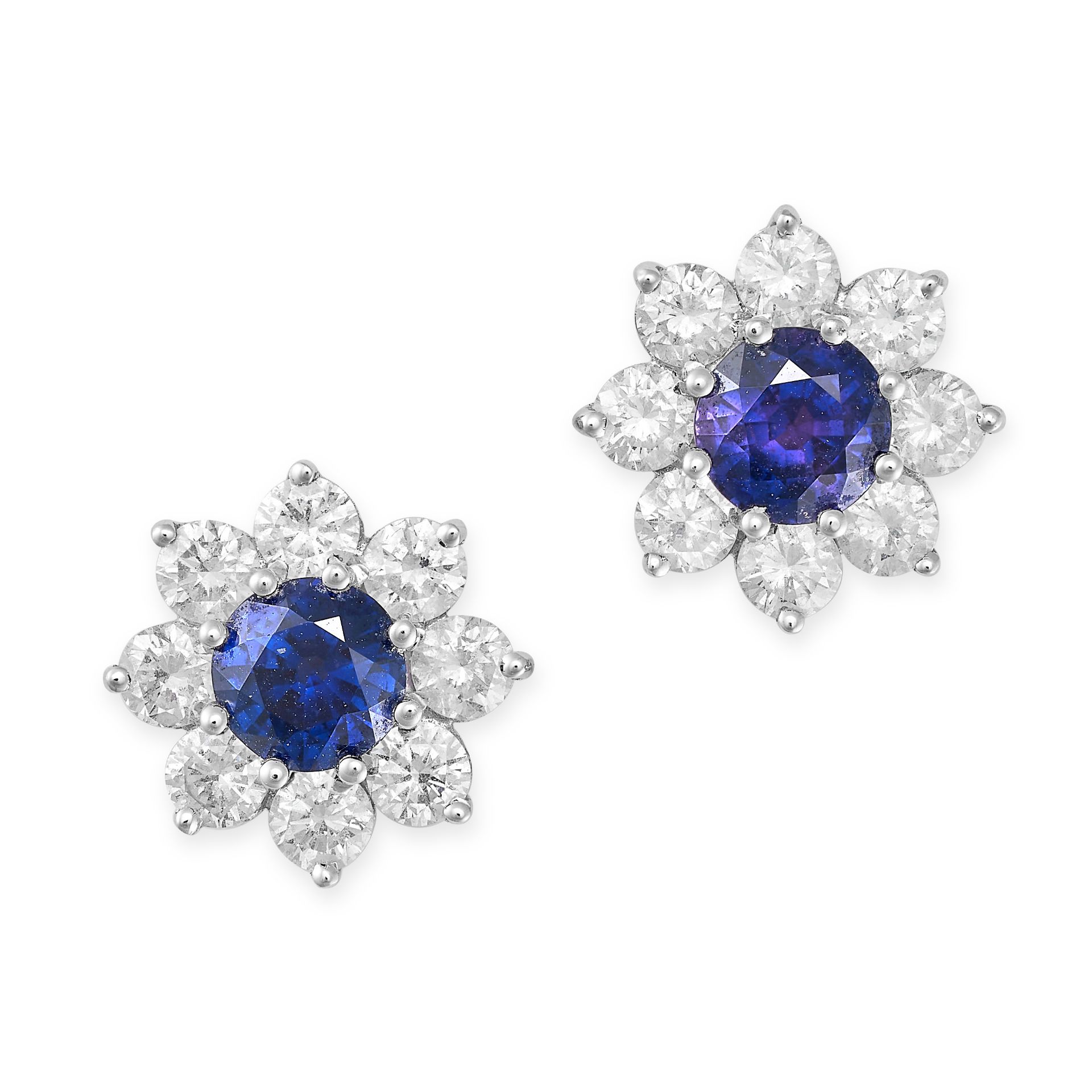 A PAIR OF SAPPHIRE AND DIAMOND CLUSTER EARRINGS in 18ct white gold, each set with a round cut