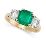 A COLOMBIAN EMERALD AND DIAMOND THREE STONE RING in yellow gold, set with an octagonal step cut