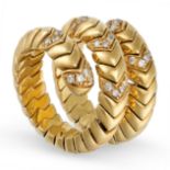 A DIAMOND DRESS RING in 18ct yellow gold and steel, the coiled snake-like body formed of articulated