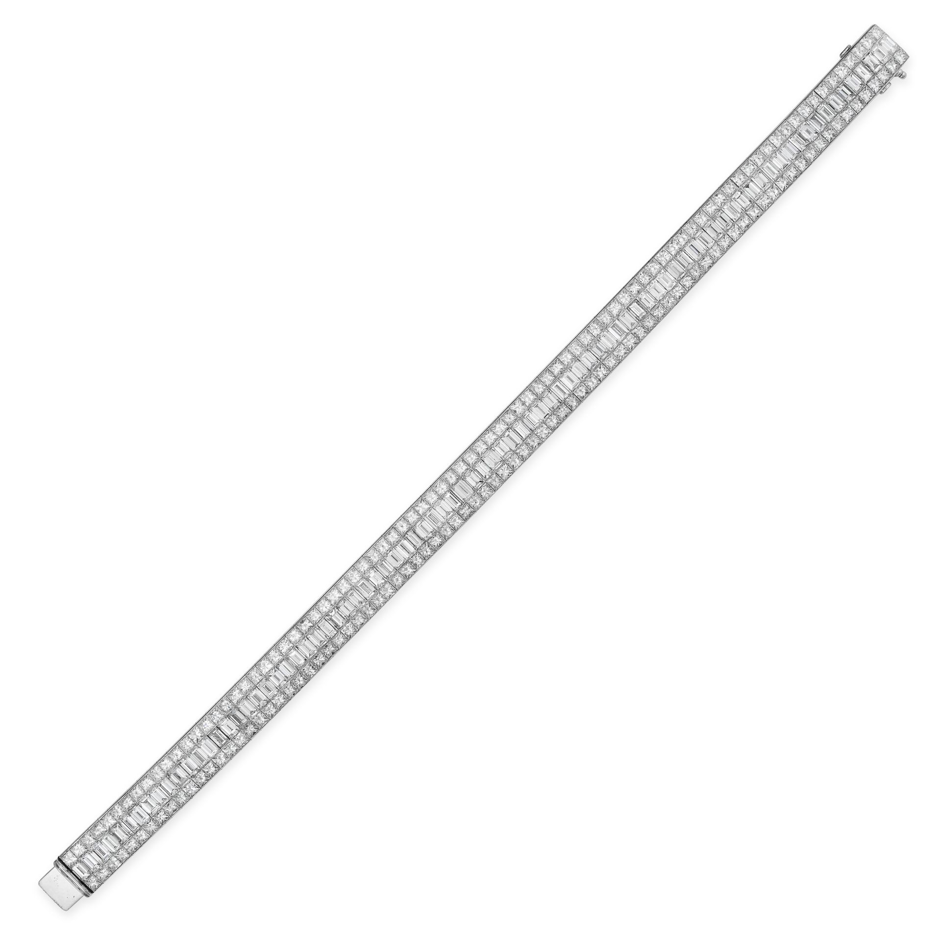 A DIAMOND BRACELET in 18ct white gold, set with a row of baguette cut diamonds between two rows of