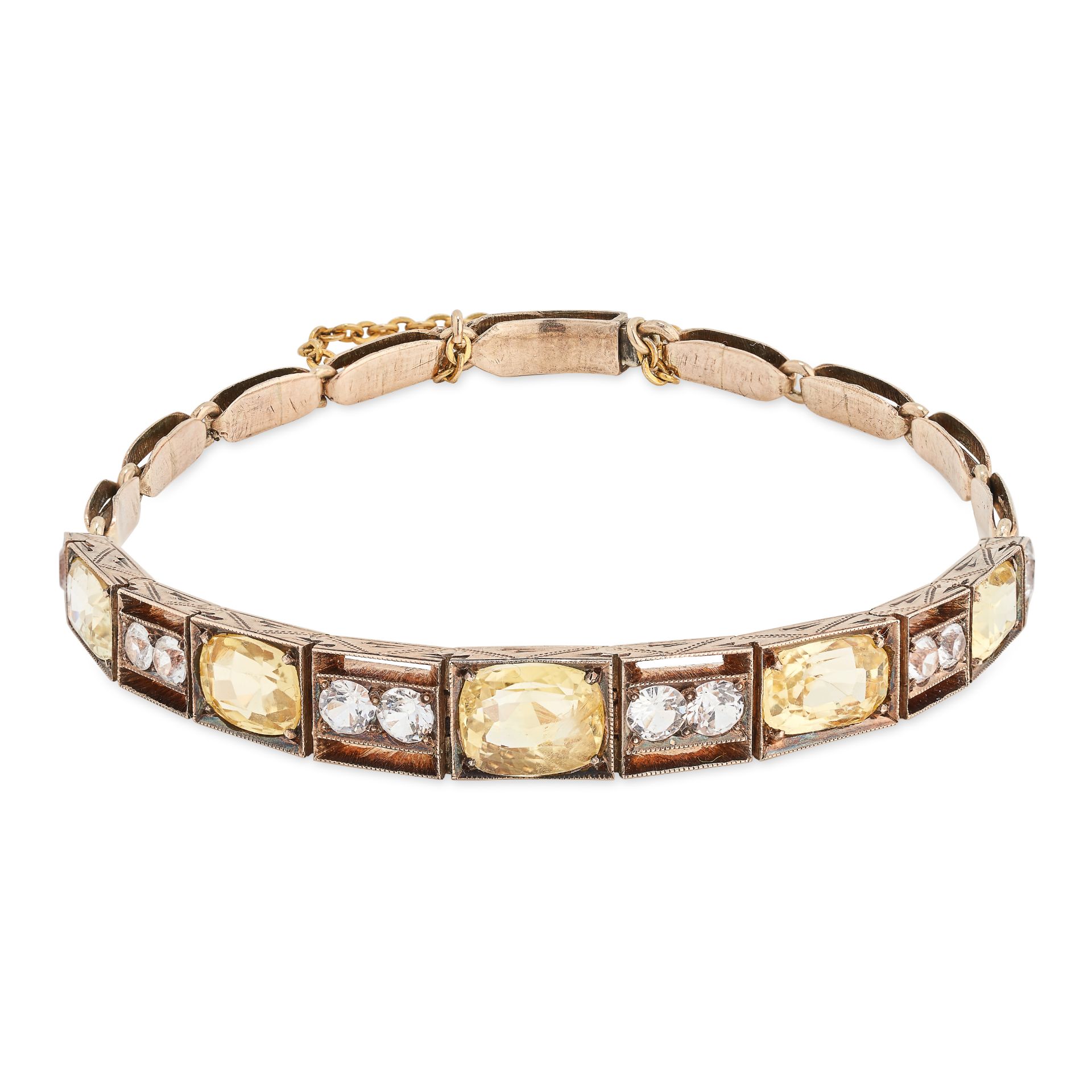 AN ANTIQUE YELLOW AND WHITE SAPPHIRE BRACELET in yellow gold, set with a row of cushion and oval ...