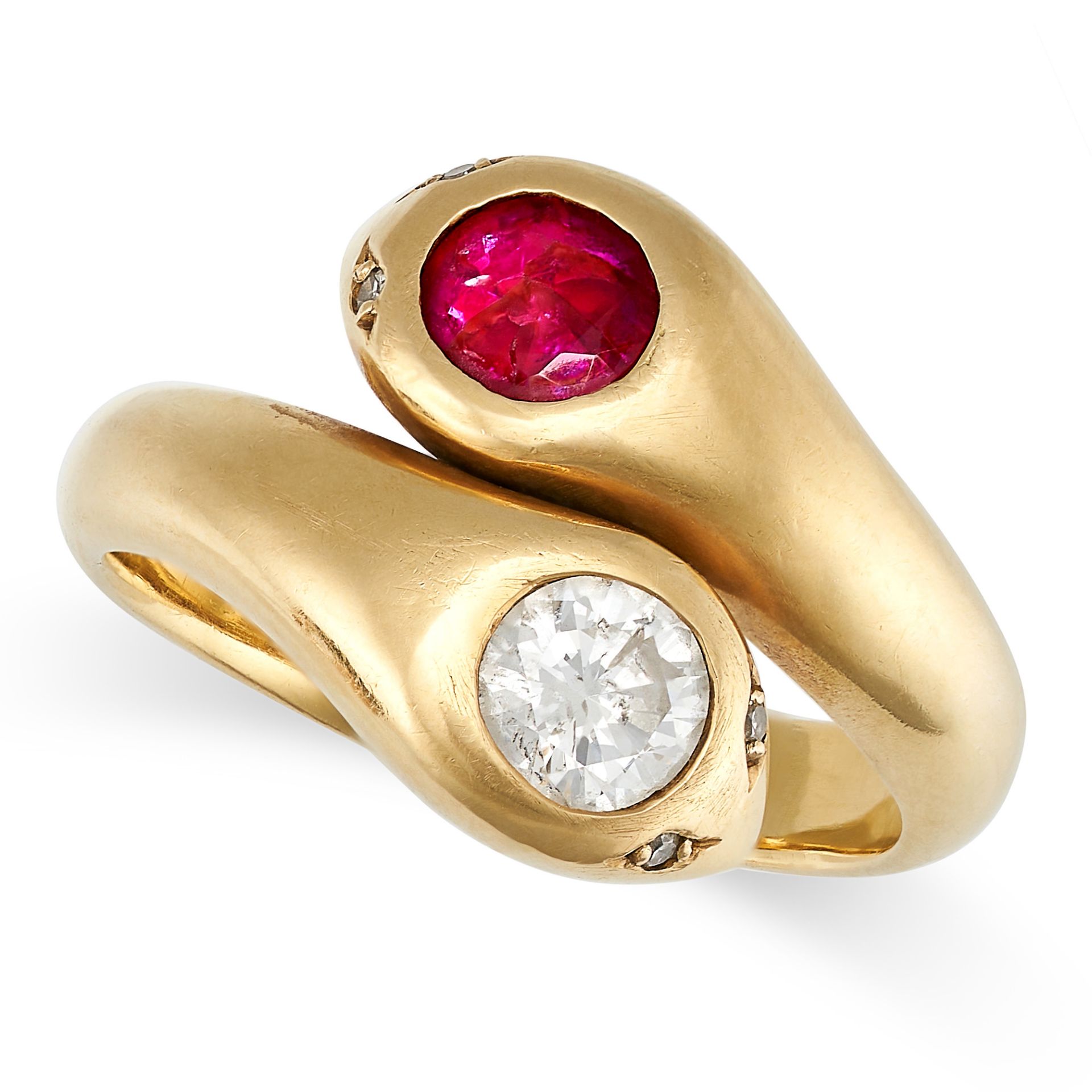 A RUBY AND DIAMOND SNAKE RING in yellow gold, designed as a pair of coiled snakes, the heads set ...