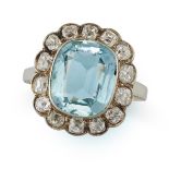 A VINTAGE AQUAMARINE AND DIAMOND CLUSTER RING in 14ct white gold, set with a cushion cut aquamari...