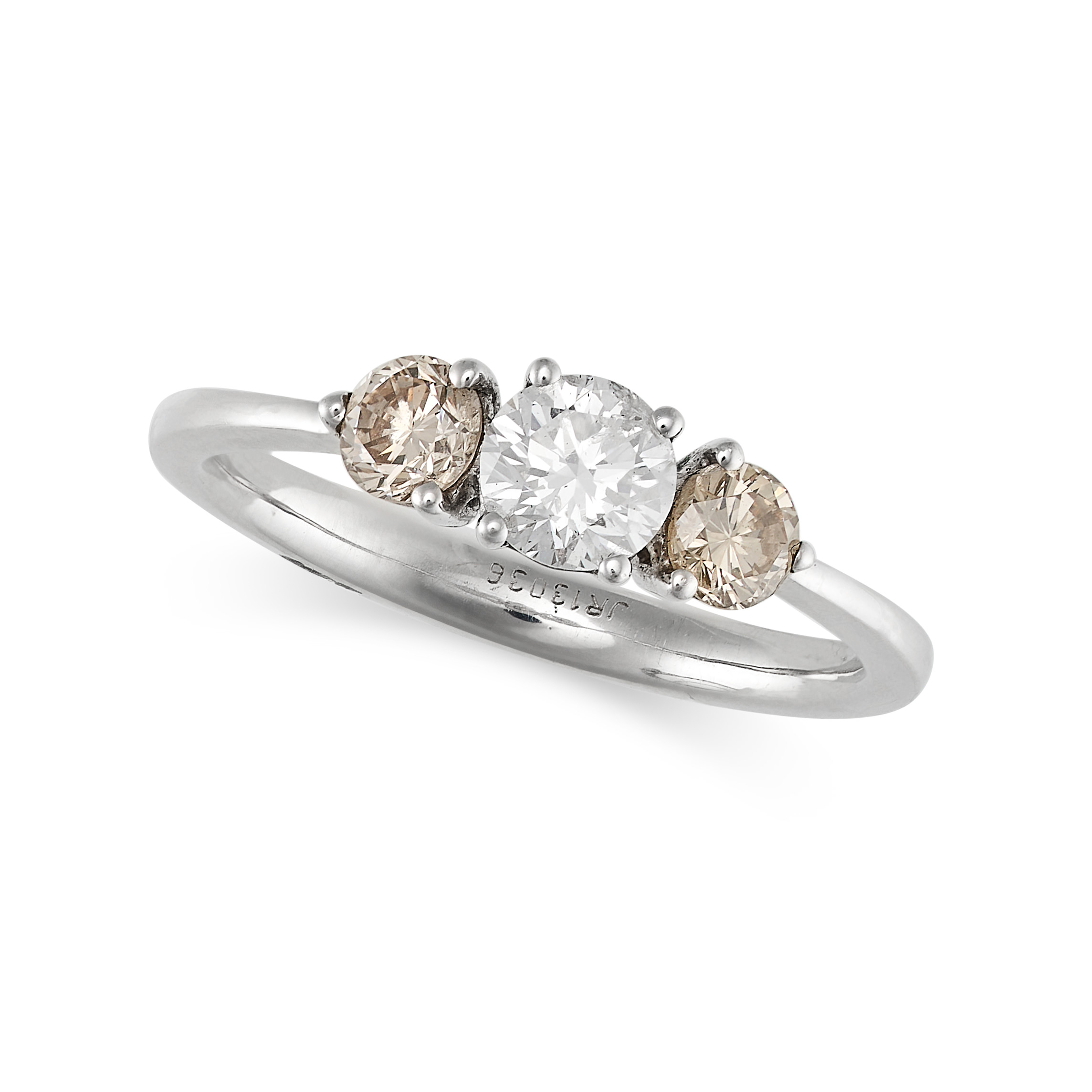 A DIAMOND THREE STONE RING in white gold, set with a round brilliant cut diamond accented by two ...