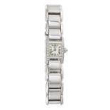 CARTIER, A DIAMOND TANKISSIME WRISTWATCH in 18ct white gold, the square watch face accented by ro...