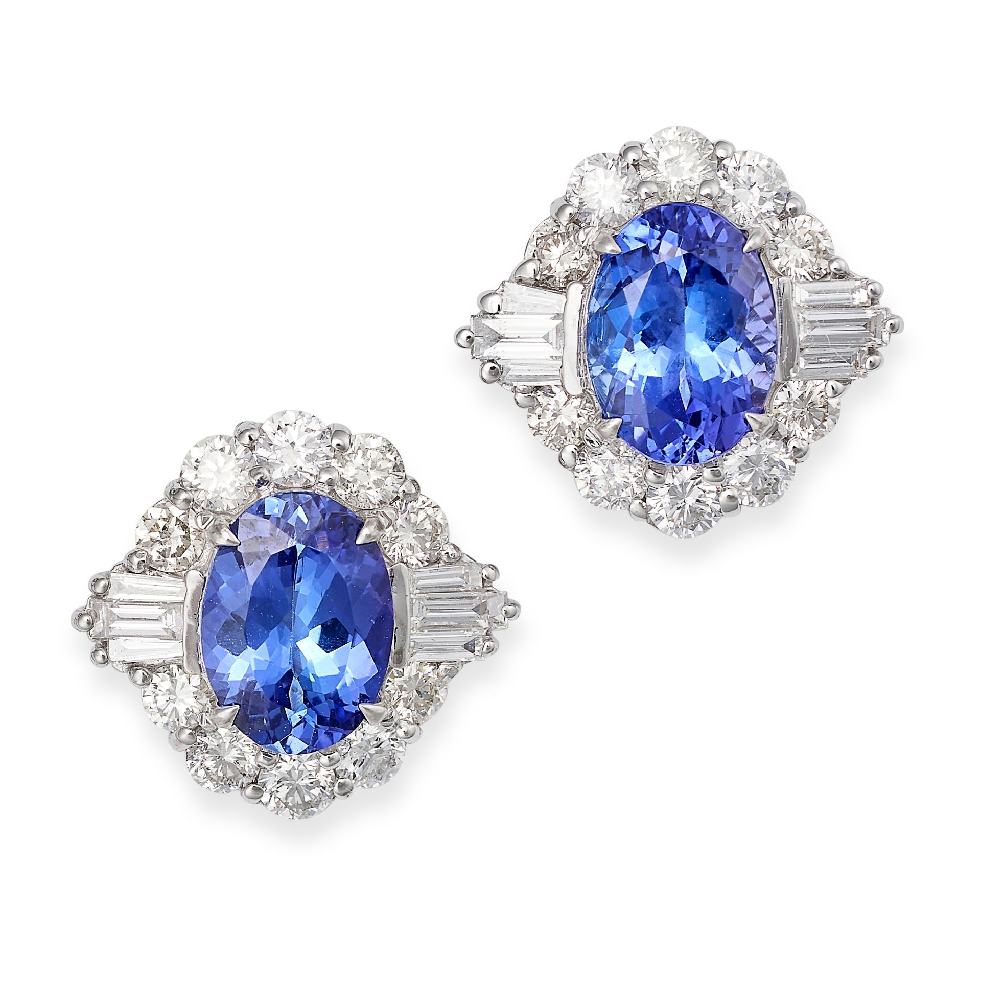 A PAIR OF TANZANITE AND DIAMOND STUD EARRINGS in 18ct white gold, each set with an oval cut tanza...