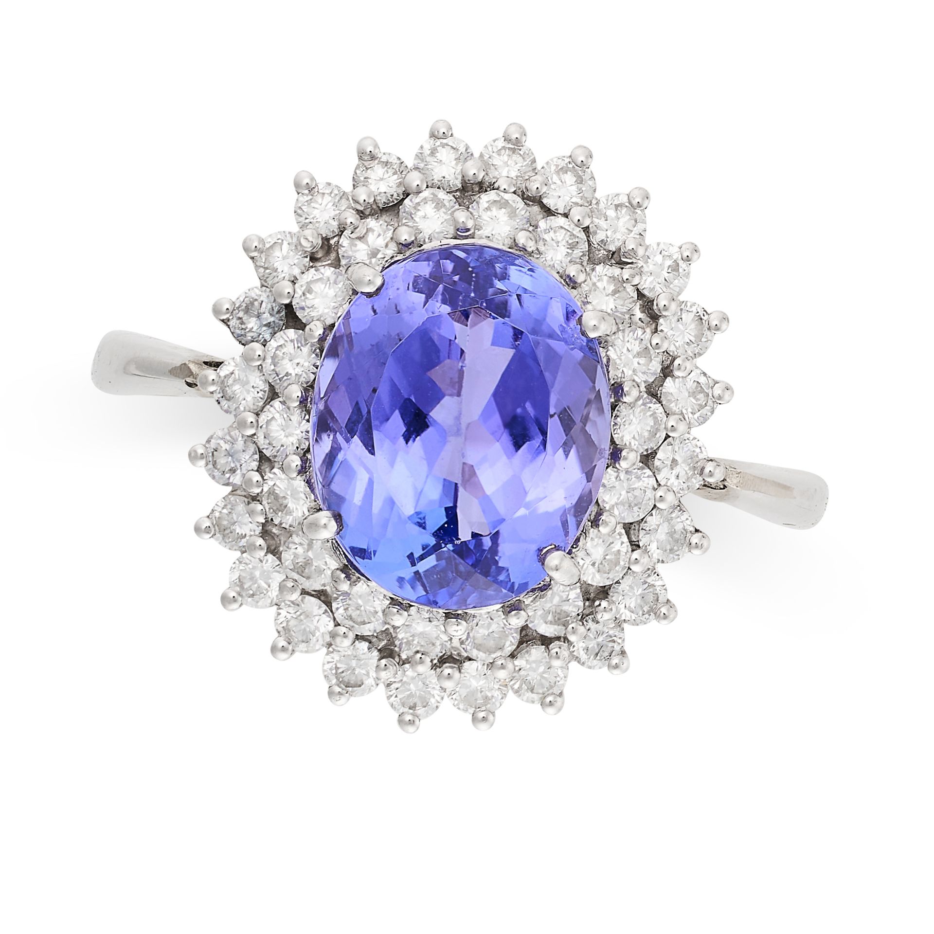 A TANZANITE AND DIAMOND CLUSTER RING in 18ct white gold, set with an oval cut tanzanite of approx...