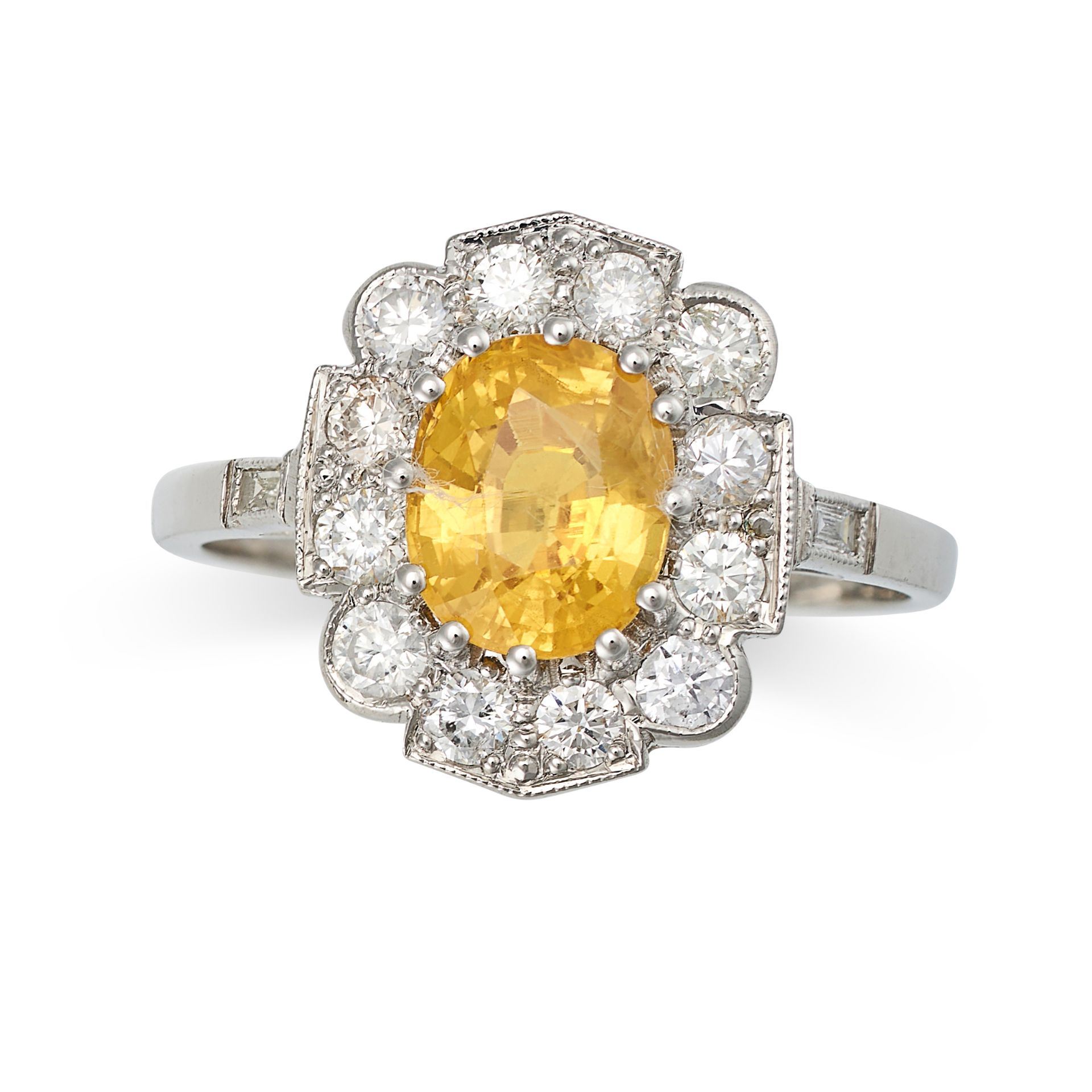 A YELLOW SAPPHIRE AND DIAMOND CLUSTER RING in platinum, set with an oval cut yellow sapphire of a...