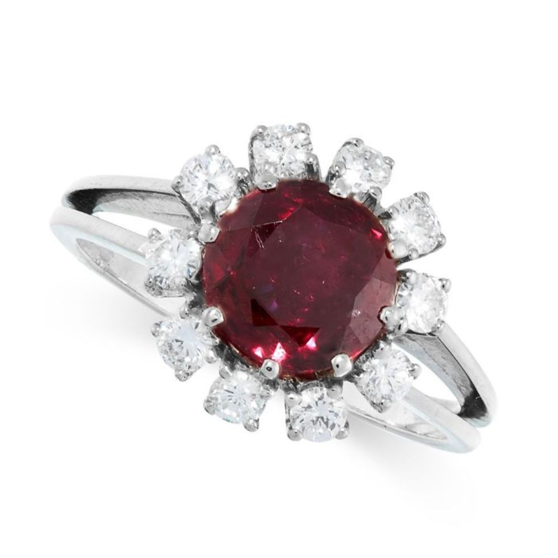 NO RESERVE - AN UNHEATED RUBY AND DIAMOND RING set with a round cut ruby of 2.32 carats, within a...