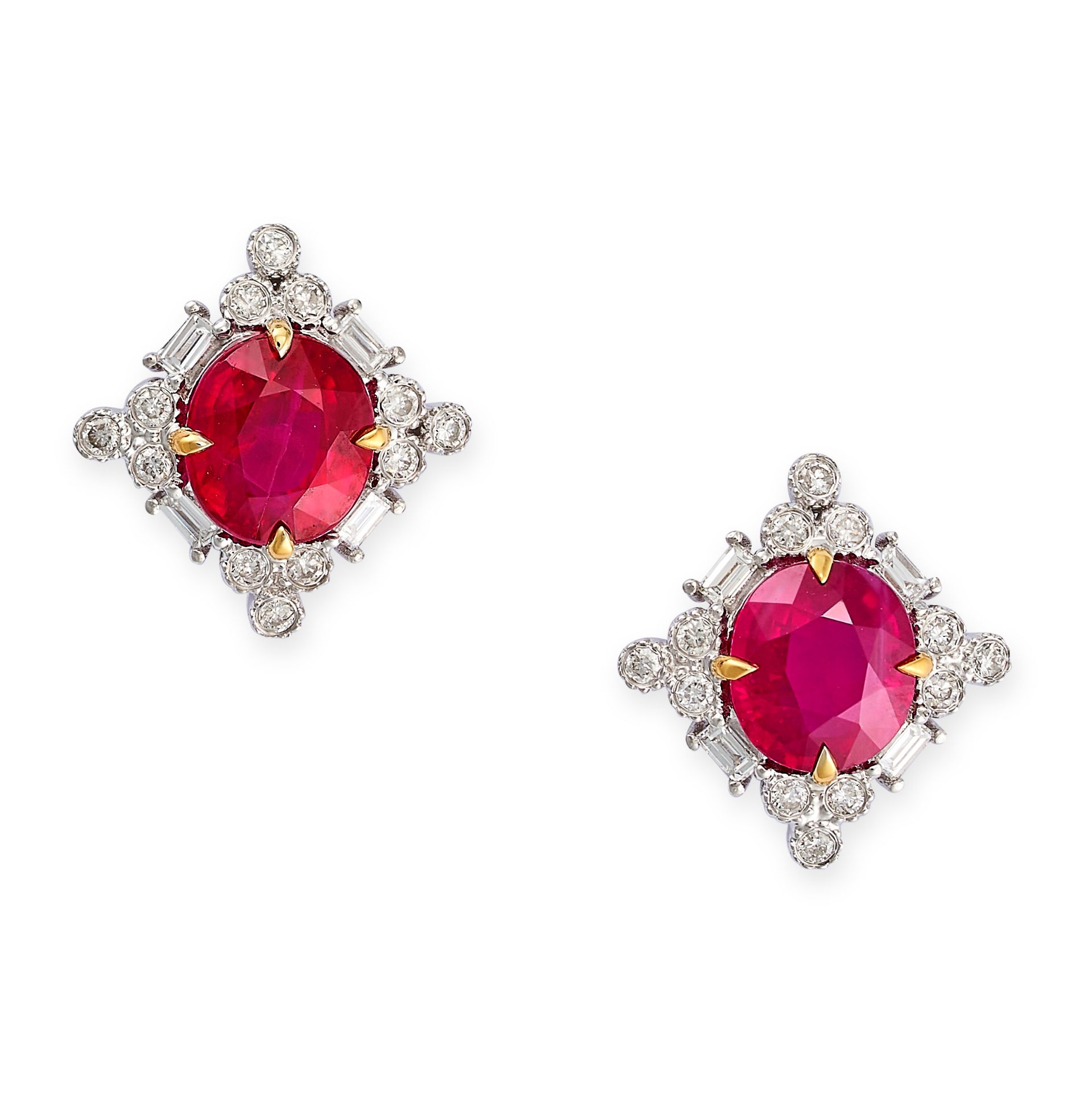 A PAIR OF RUBY AND DIAMOND CLUSTER EARRINGS in 18ct white gold, each set with an oval cut ruby in...