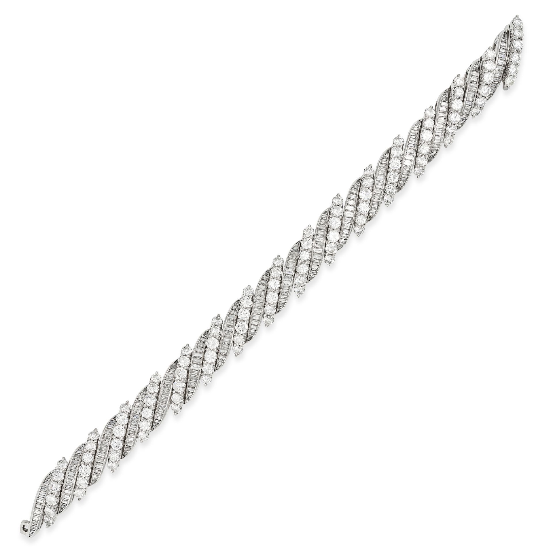 A DIAMOND BRACELET comprising a row of alternating links set with round brilliant cut diamonds an...