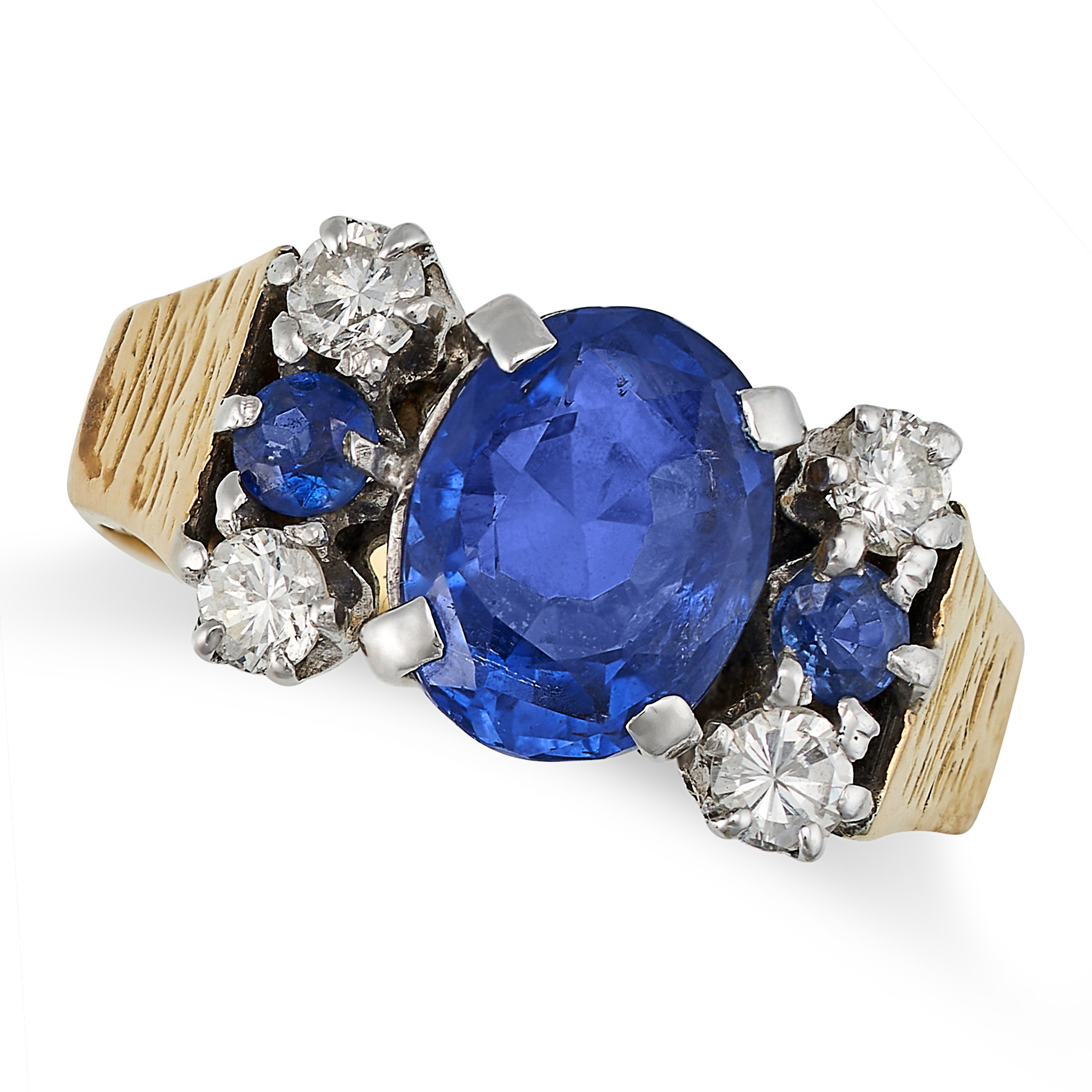 A VINTAGE CEYLON NO HEAT SAPPHIRE AND DIAMOND RING in 18ct yellow gold, set with an oval cut sapp...