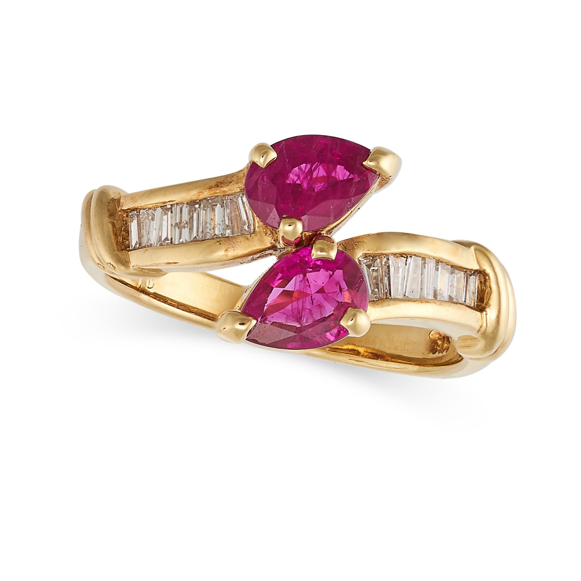 A RUBY AND DIAMOND CROSSOVER RING in 18ct yellow gold, terminating in two pear cut rubies, accent...