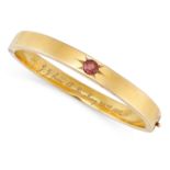 AN ANTIQUE VICTORIAN RED SPINEL BANGLE in yellow gold, the bangle set with a round cut red spinel...