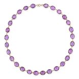 AN AMETHYST NECKLACE in 18ct yellow gold, set with a row of faceted oval cut amethysts, stamped 7...