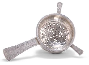 AN ARTS AND CRAFTS SILVER TEA STRAINER