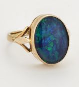 A 9 CARAT GOLD COMPOSITE BLACK OPAL RING