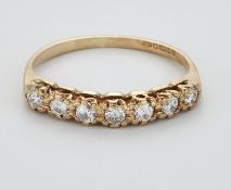 A 9 CARAT GOLD DIAMOND HALF HOOP RING