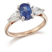 AN 18 CARAT ROSE GOLD SAPPHIRE AND DIAMOND THREE STONE RING