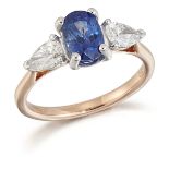 AN 18 CARAT ROSE GOLD SAPPHIRE AND DIAMOND THREE STONE RING