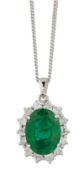 AN 18 CARAT WHITE GOLD EMERALD AND DIAMOND CLUSTER PENDANT ON CHAIN