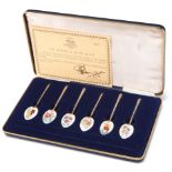 A SET OF SIX ELIZABETH II SILVER-GILT AND ENAMEL LIMITED EDITION SPOONS