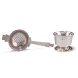 AN ART DECO SILVER TEA STRAINER ON STAND