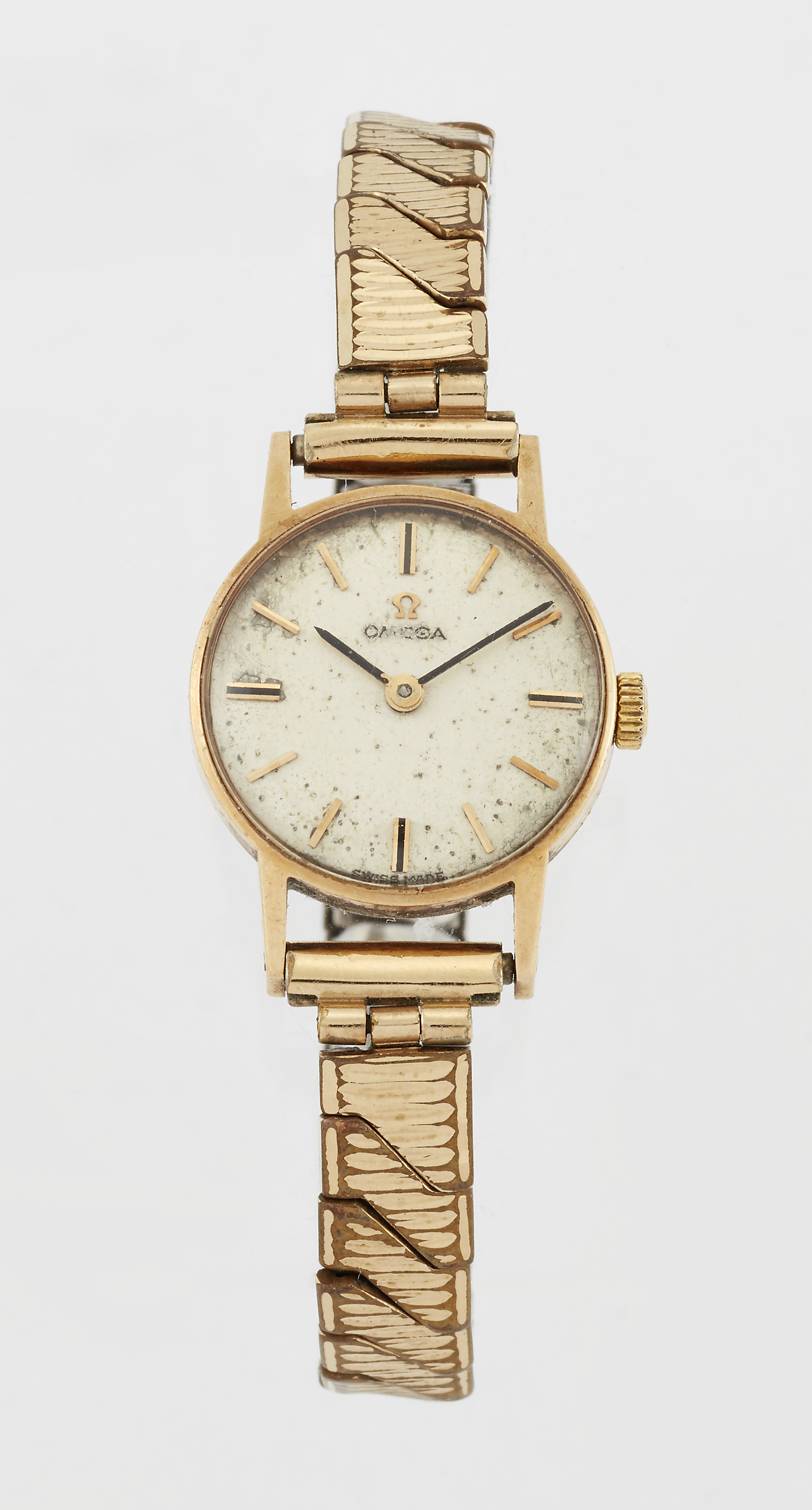 A LADY'S 9 CARAT GOLD OMEGA WATCH