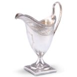 A GEORGE III SILVER CREAM JUG