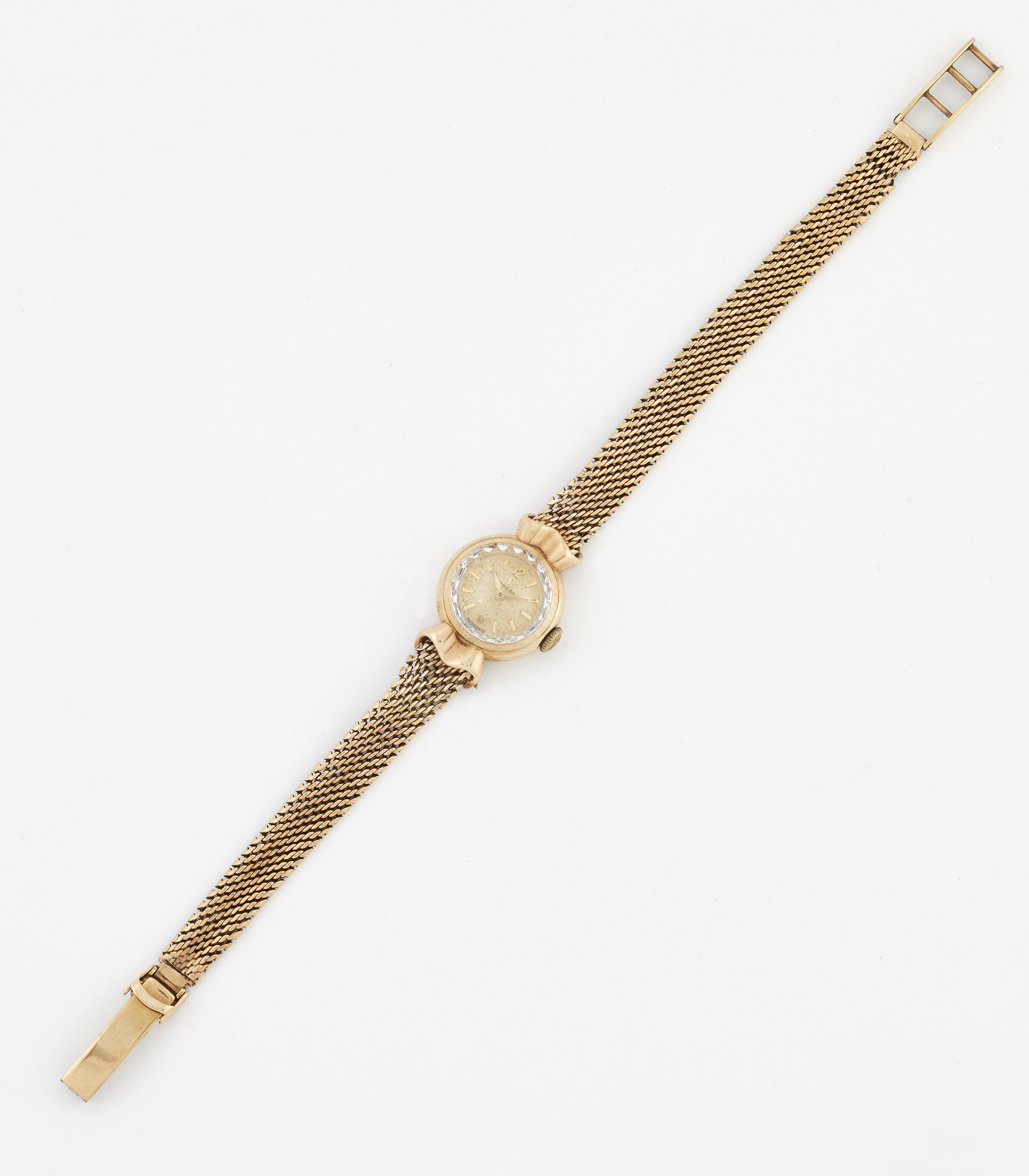 A LADY'S 9 CARAT GOLD OMEGA BRACELET WATCH