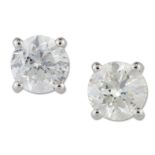 A PAIR OF SOLITAIRE DIAMOND EARRINGS