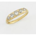 AN 18 CARAT GOLD DIAMOND FIVE STONE RING