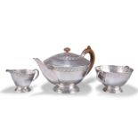 AN ARTS AND CRAFTS SILVER THREE-PIECE TEA SERVICE