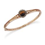 A LATE 19TH CENTURY TIGER'S EYE, DIAMOND AND SPLIT PEARL BANGLE