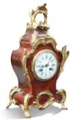 A LATE 19TH CENTURY FRENCH RED TORTOISESHELL AND ORMOLU MANTEL CLOCK
