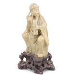A CHINESE CARVED SOAPSTONE FIGURE OF IMMORTAL CAO GUOJIU