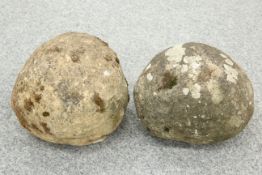 TWO WEATHERED STONE BALUSTER TREBUCHET PROJECTILES