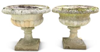 A LARGE PAIR OF WEATHERED COMPOSITE STONE URN-FORM PLANTERS