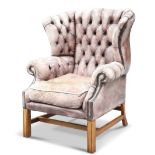 A GEORGIAN-STYLE LEATHER UPHOLSTERED WING-BACK ARMCHAIR