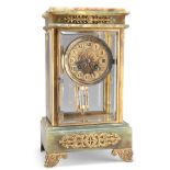 A FRENCH GILT-METAL MOUNTED ONYX FOUR-GLASS MANTEL CLOCK