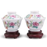 A PAIR OF CHINESE FAMILLE ROSE CUPS AND COVERS